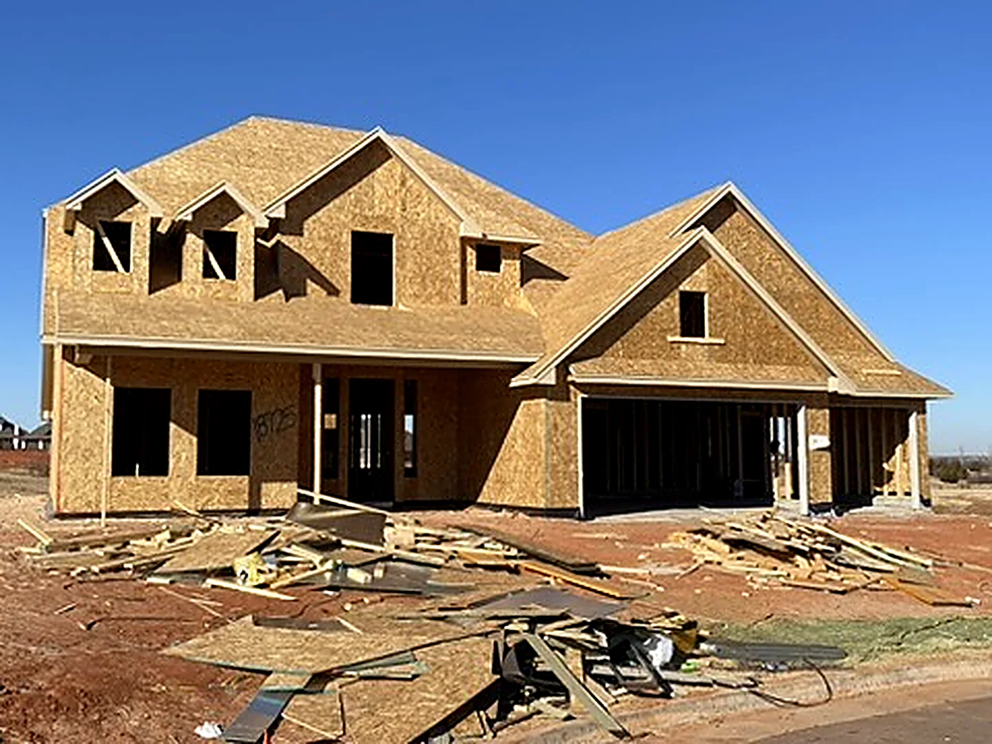 Before: two-story home framed and sheathed